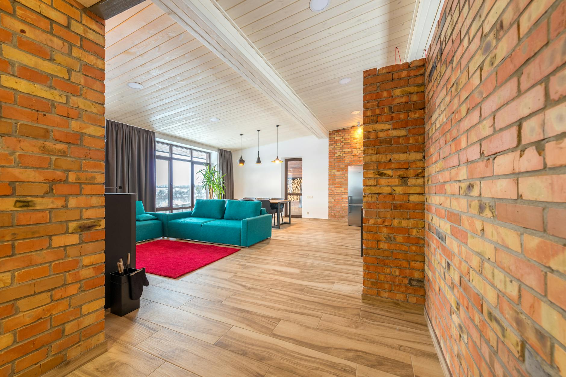 Curated living room with teal sofa and large-scale art